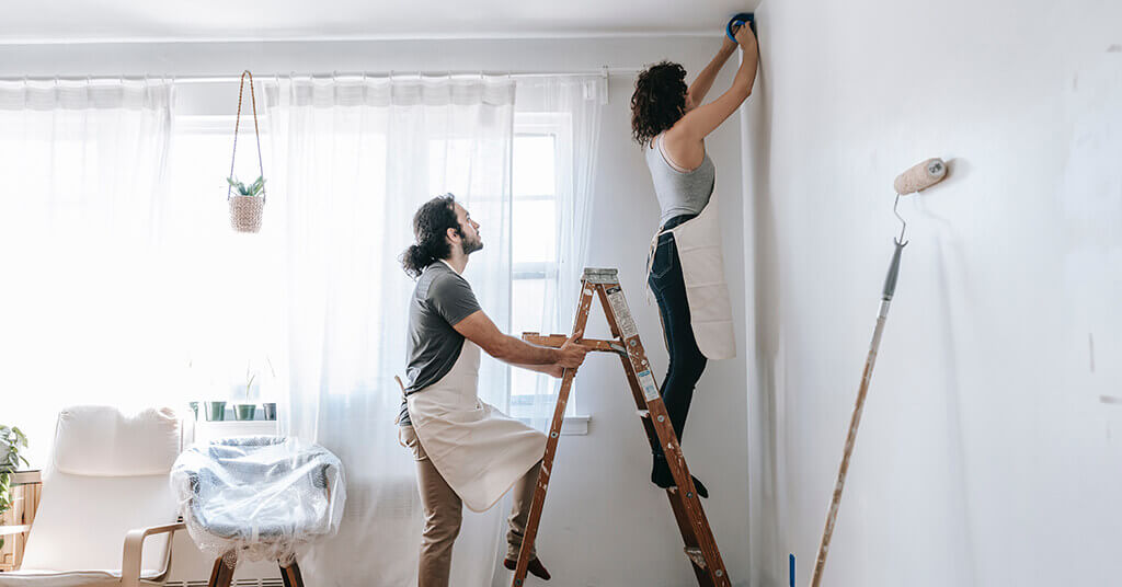 couple painting a wall