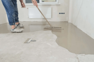 men painting the concrete floor