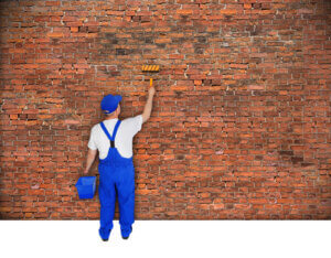 man painting bricks
